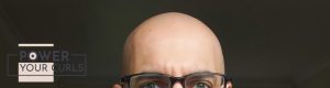 The top of a bald man’s head.