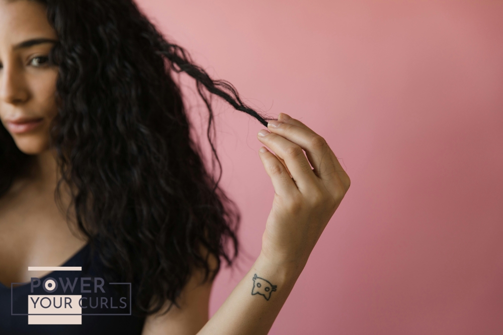 A girl holding onto her hair strands.