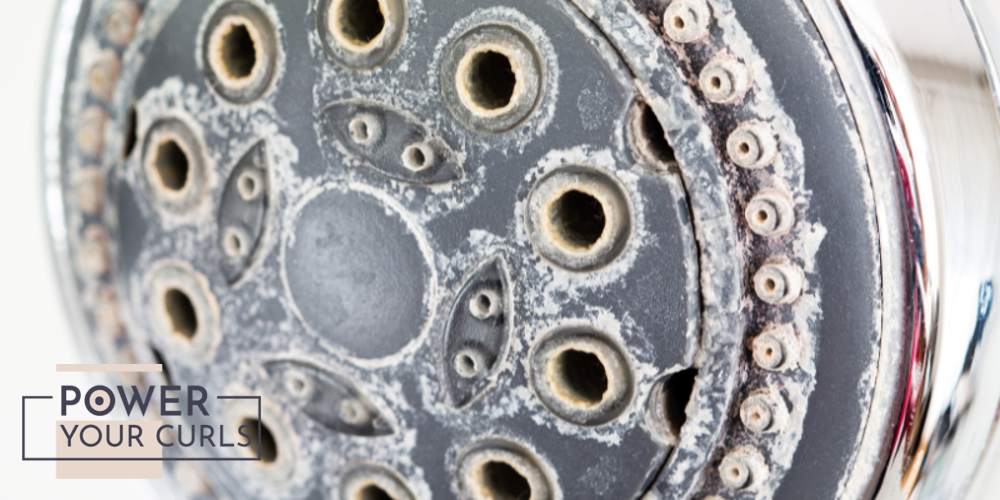 A showerhead caked with limescale