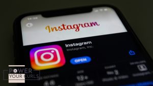 An iPhone displays the Instagram logo.