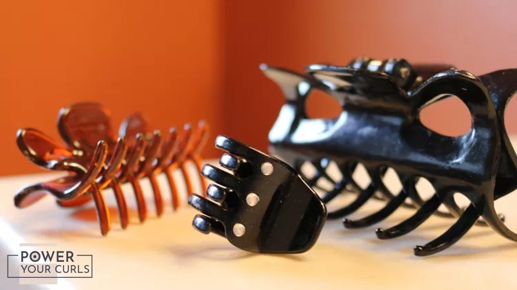 Claw clips of different styles are spread out on a table.